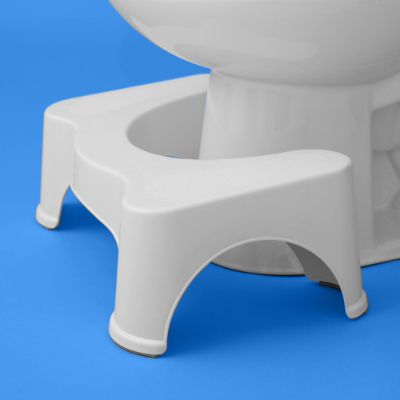 a squatty potty against a toilet